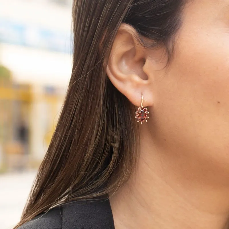dangling Lucia earrings yellow gold inlaid with garnet stones