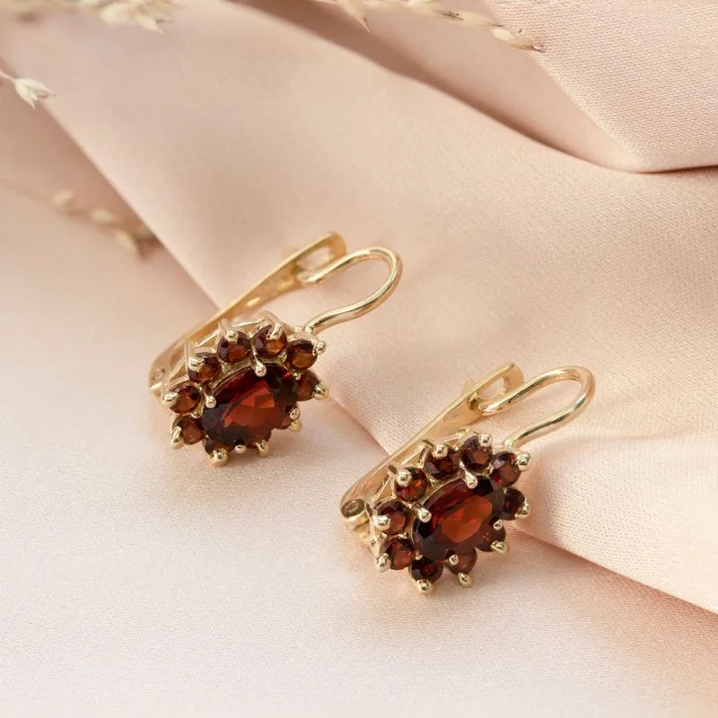 dangling Lucia earrings yellow gold inlaid with garnet stones