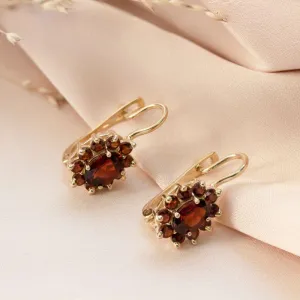 dangling Lucia earrings yellow gold inlaid with garnet stones